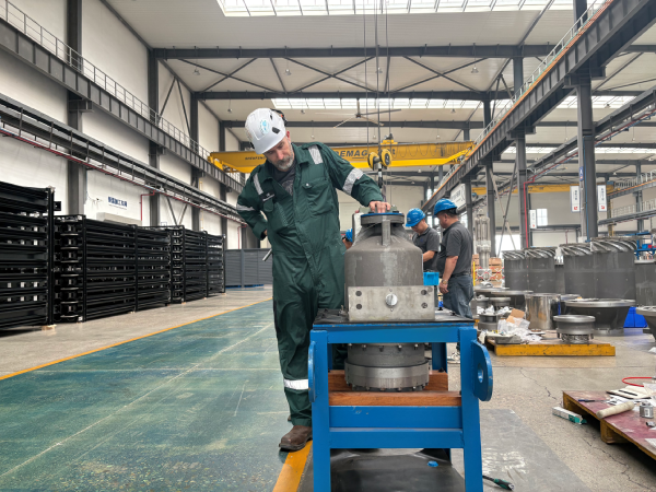 Engineers inspecting industrial equipment in a factory workshop