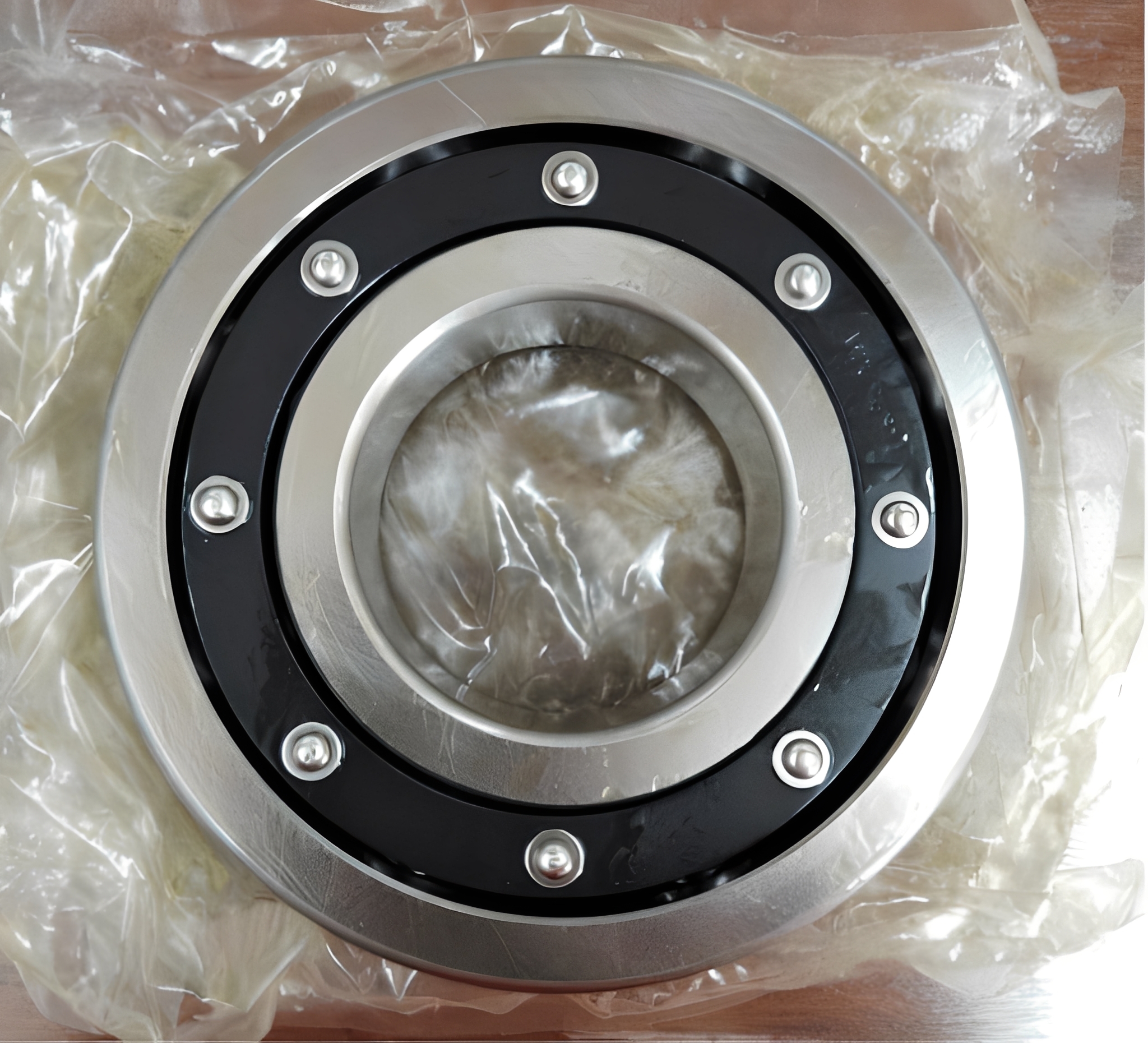 Close-up of a new mechanical bearing featuring a black retainer ring and silver rivets
